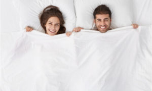 Picture of a man and a woman on the bed.